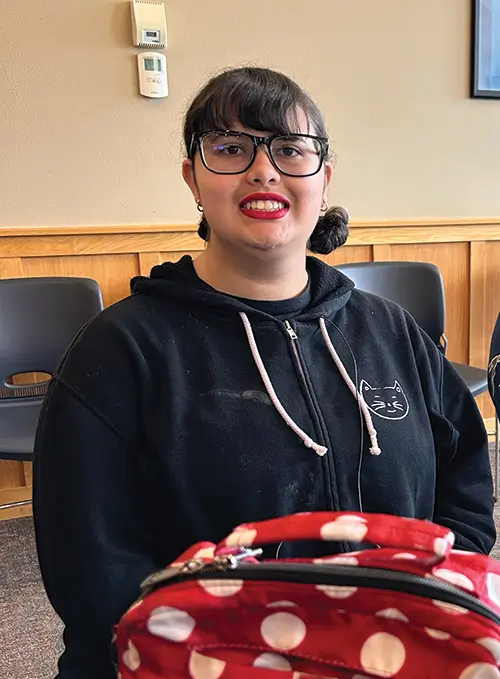 a woman student smiling at camera