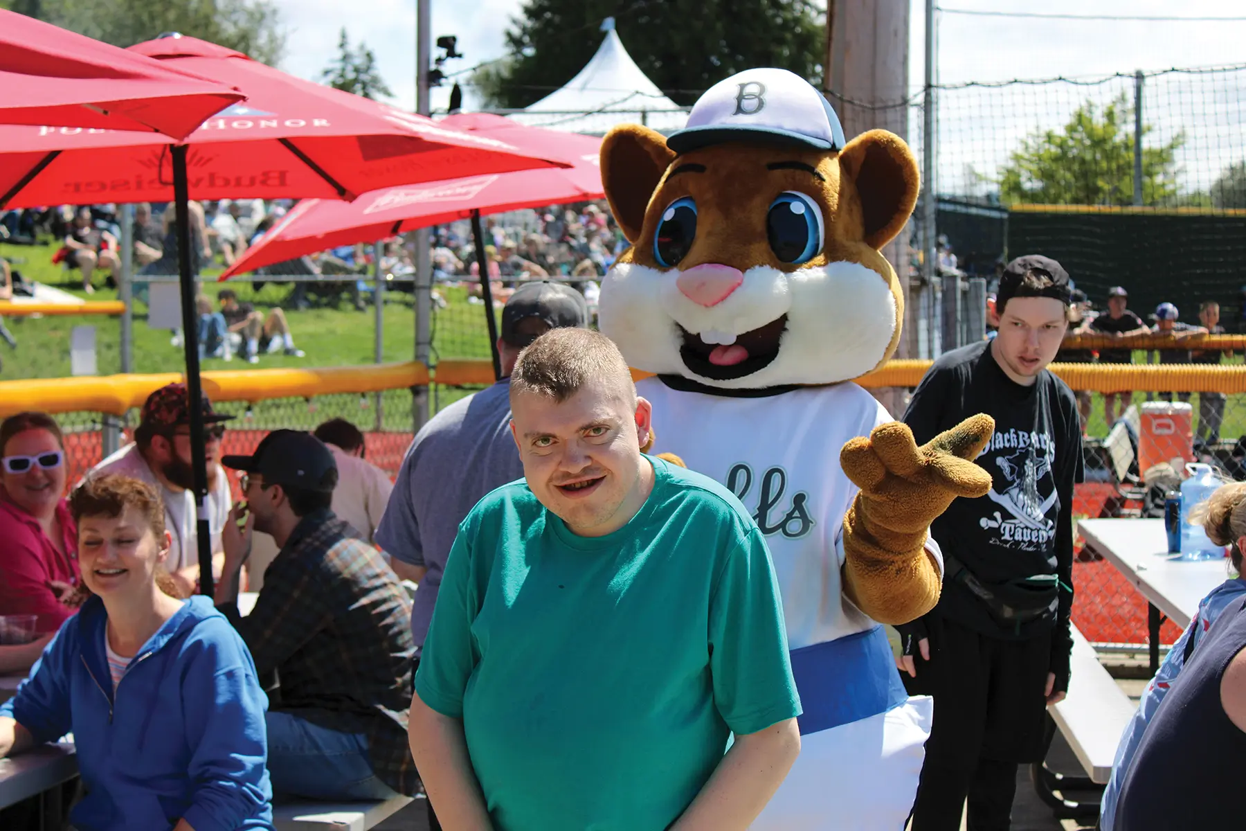 Jim at the Bellingham Bells baseball game with their mascot, Dinger.