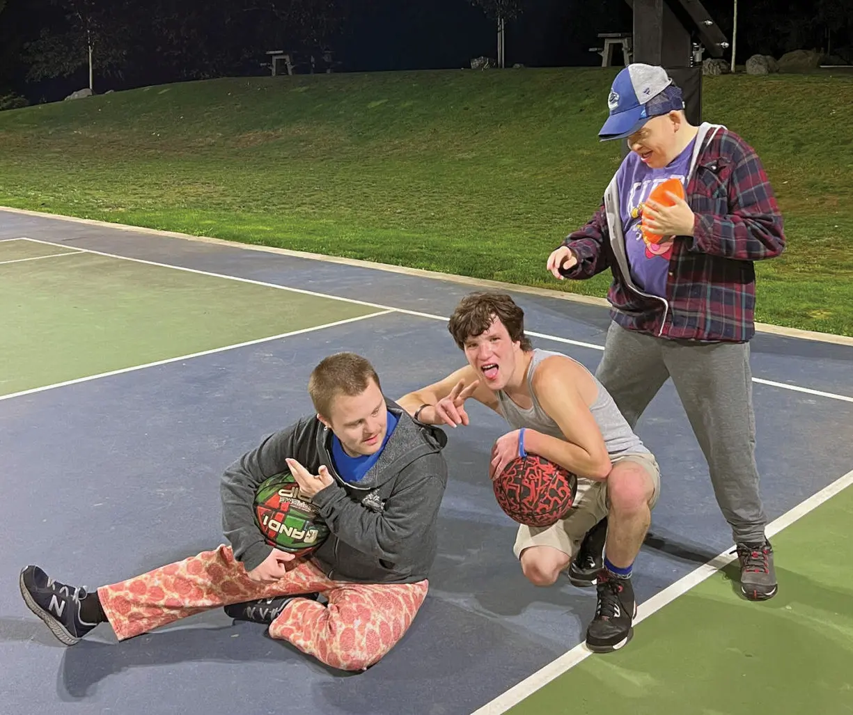 Jim playing basketball with his friends.