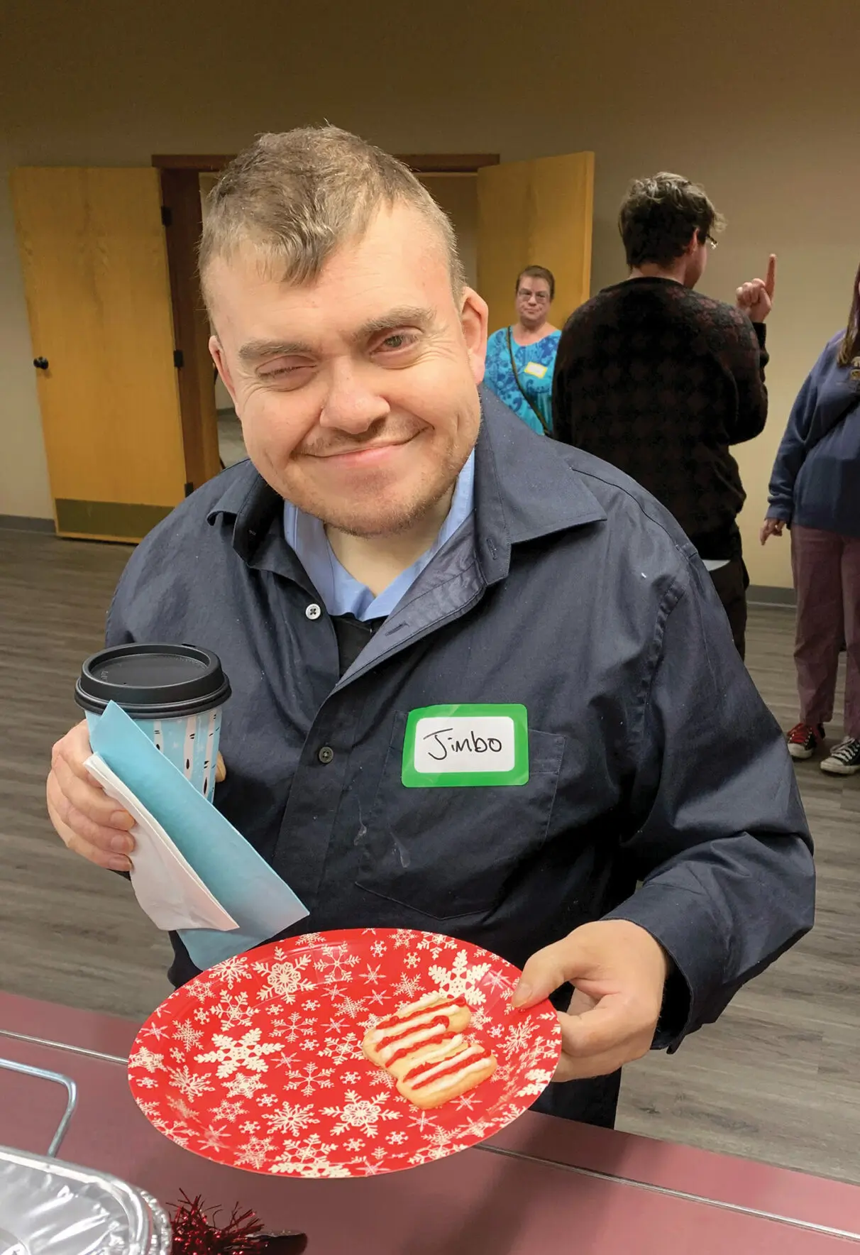 Jim holding cookies at the Christmas party.