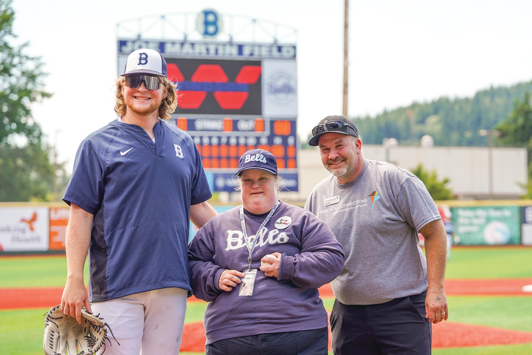Lindsey with Cascade Connections' Board Chair, Scott Duffey and a baseball player from Bellingham Bells.