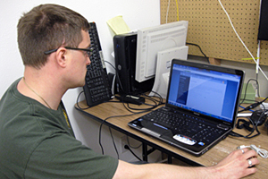 A man staring at a laptop, working