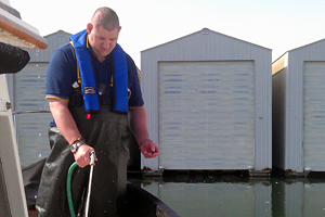 A man sparying liquid in a working environment