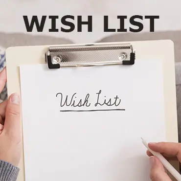 a clipboard with a text says wish list. a person is holding a pencil.